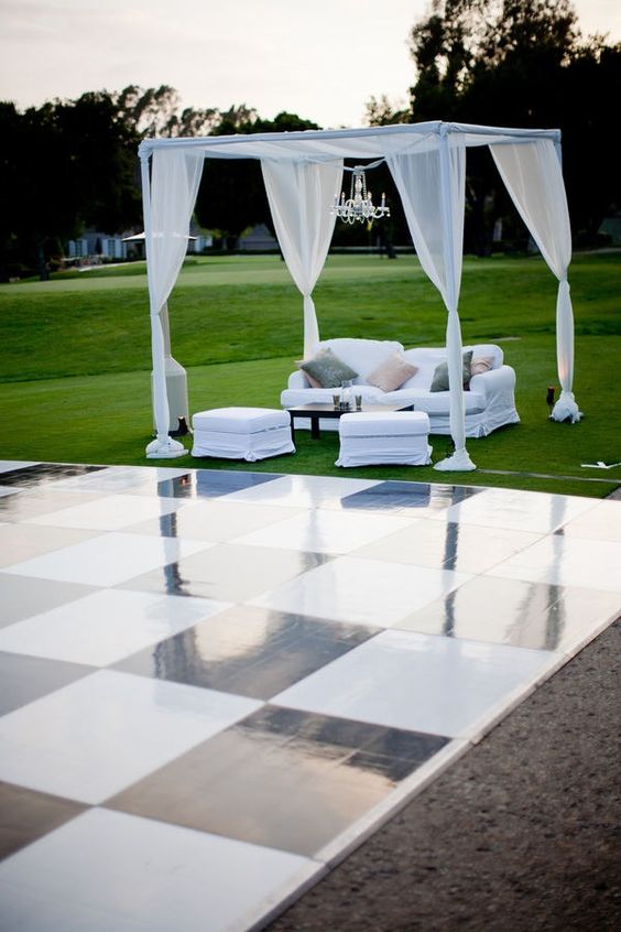 outdoor black & white dance floor for wedding and pipe and drape wedding booth